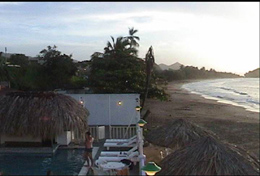 Un bao de piscina mientras se ve el sol hundirse en el mar